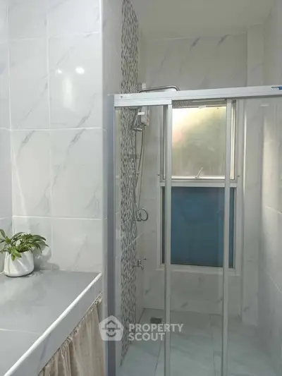 Modern bathroom with glass shower and elegant tile design