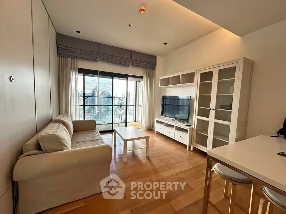 Modern living room with city view, featuring cozy sofa, TV unit, and elegant wooden flooring.