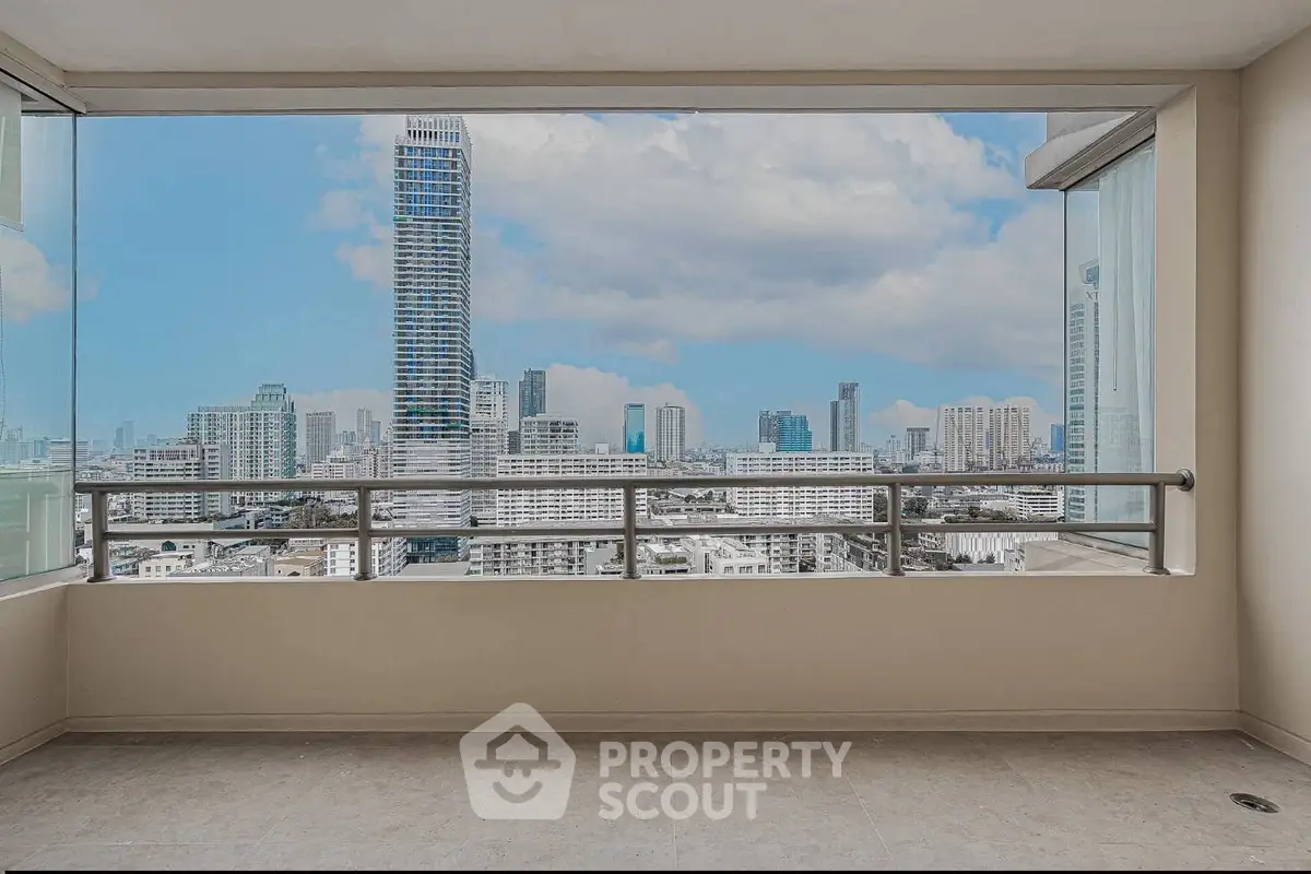 Stunning cityscape view from a spacious balcony in a modern high-rise apartment.