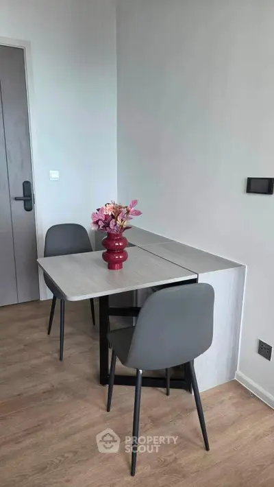 Modern dining area with sleek table and chairs, perfect for compact living spaces.