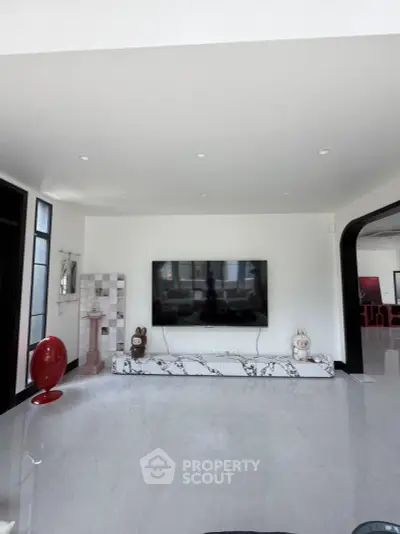 Spacious modern living room with sleek marble TV stand and contemporary decor.
