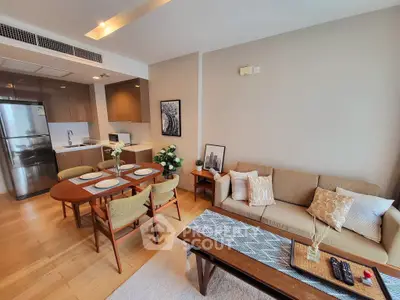 Modern open-layout living room with kitchen, stylish decor, and cozy seating area.