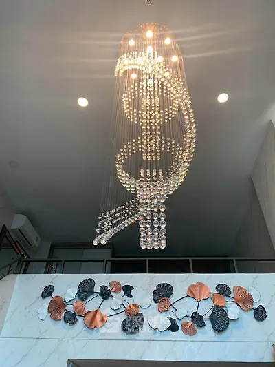 Luxurious modern chandelier in elegant interior with artistic wall decor