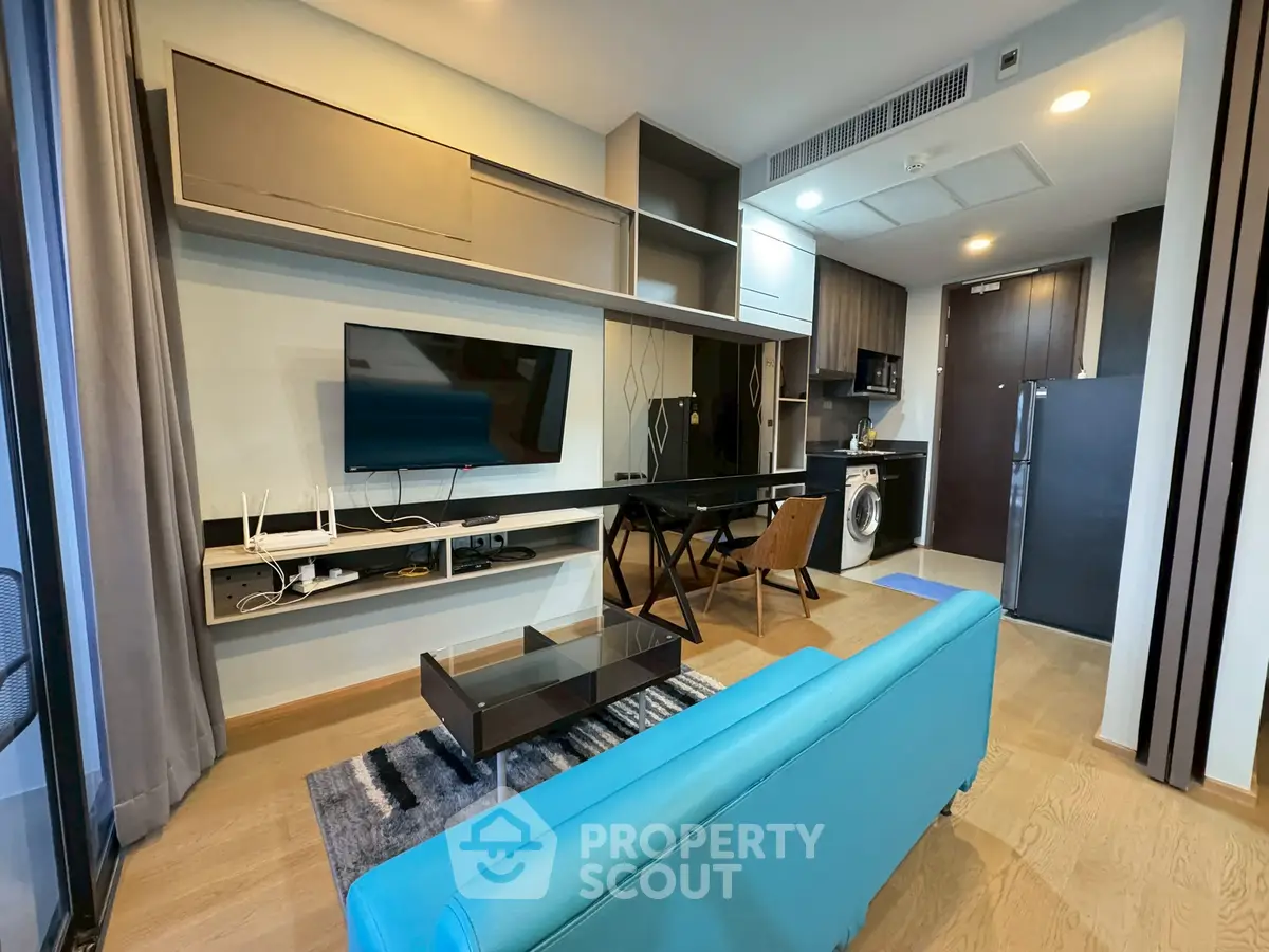 Modern living room with sleek furniture and integrated kitchen appliances