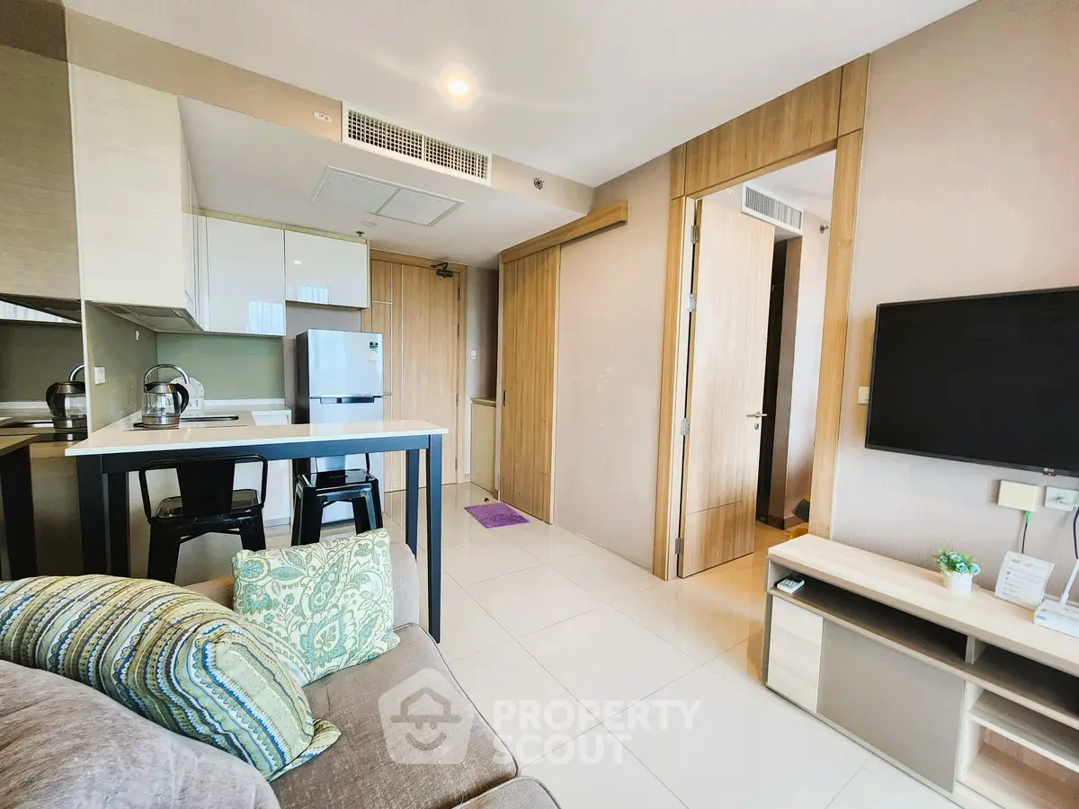 Modern open-layout living room with stylish kitchen and cozy decor