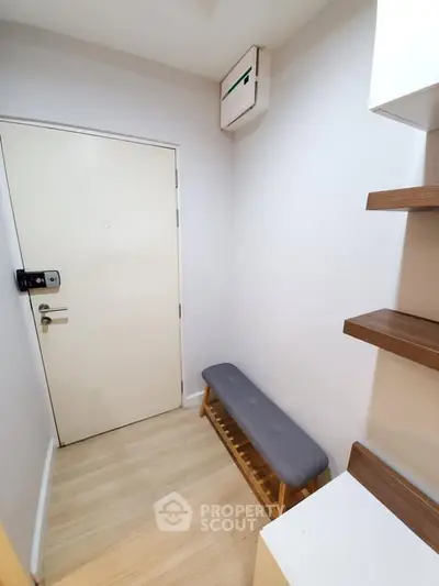 Modern entryway with sleek bench and wooden shelves, perfect for stylish urban living.