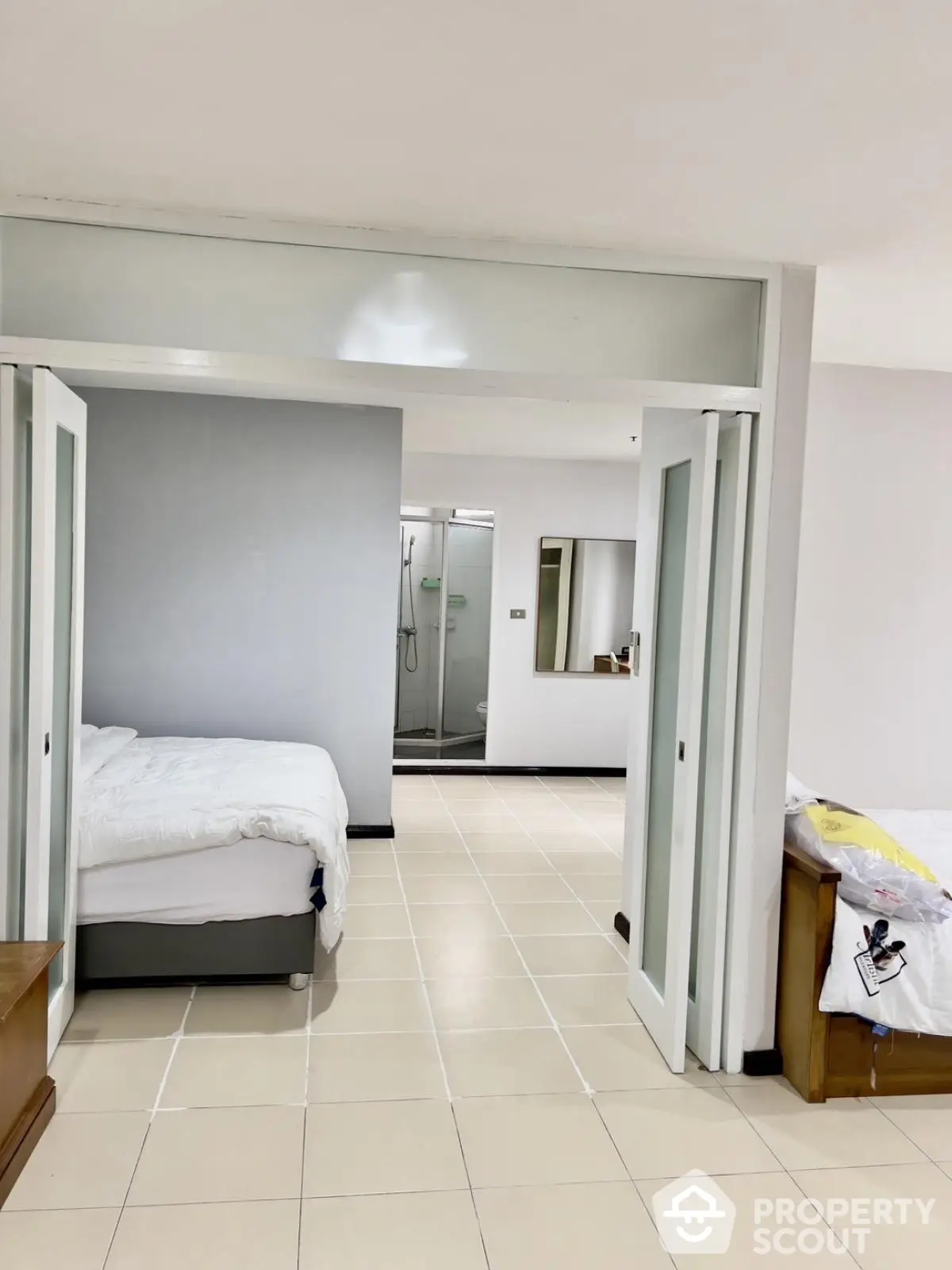 Spacious bedroom with sliding doors and modern ensuite bathroom