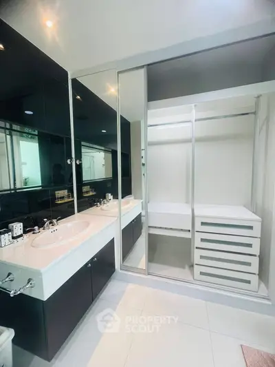 Modern bathroom with dual sinks and sleek cabinetry in a contemporary home.