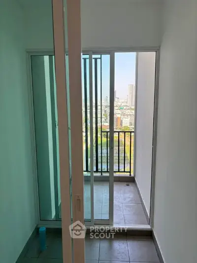 Modern apartment balcony with city view and sliding glass doors