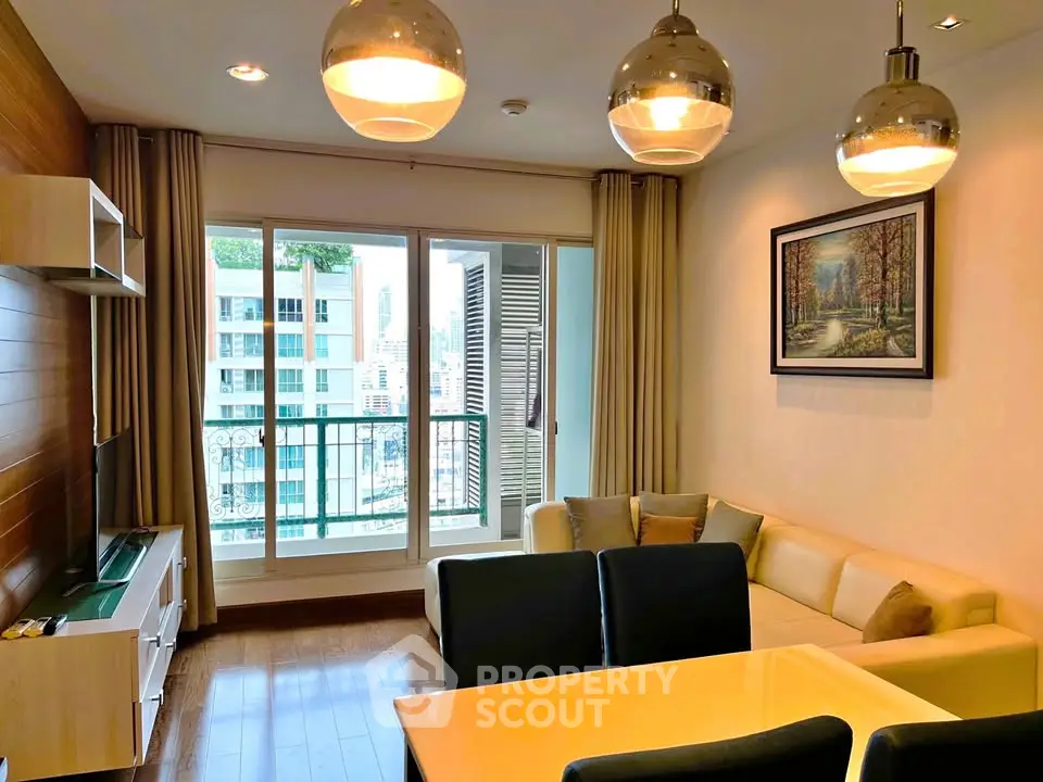 Modern living room with stylish decor and large windows offering city views.