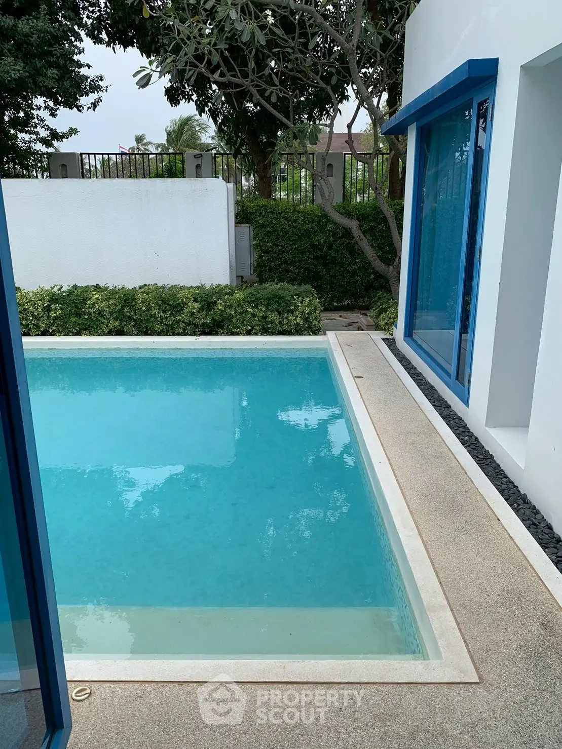 Luxurious private pool with modern design and lush greenery, perfect for relaxation and entertainment.