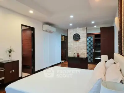 Spacious modern bedroom with elegant decor and stylish brick accent wall