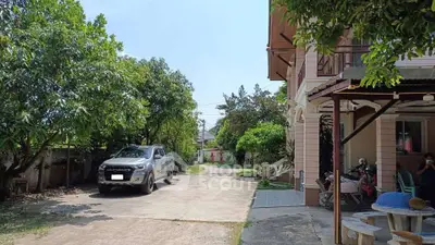 Charming residential property with lush greenery and spacious driveway