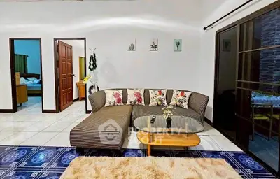 Charming living room with stylish sofa and glass coffee table, perfect for cozy gatherings.