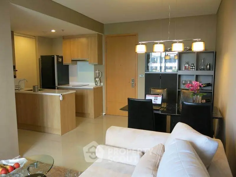 Modern open-plan living room and kitchen with stylish dining area and cozy seating.