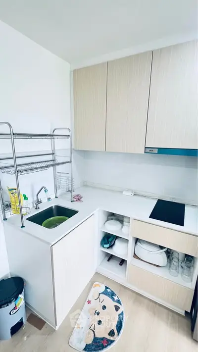 Compact modern kitchen with open shelving and sleek cabinetry, perfect for efficient cooking and storage.
