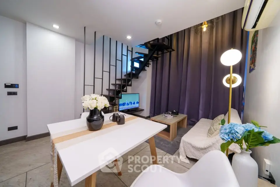 Modern duplex living room with stylish decor and open staircase