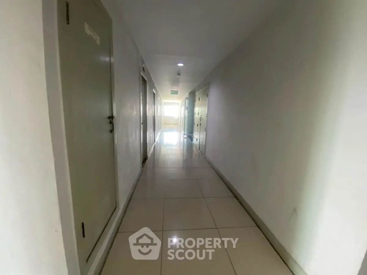 Spacious and well-lit corridor in modern apartment building