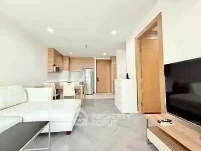Modern open-plan living room with sleek kitchen and cozy seating area