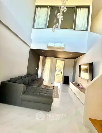 Spacious modern living room with high ceiling and elegant decor