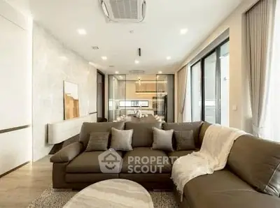 Luxurious modern living room with elegant decor and spacious seating area.