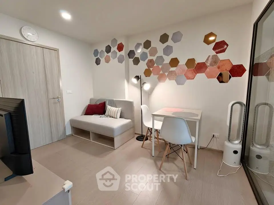 Modern living room with stylish hexagonal wall decor and cozy seating area
