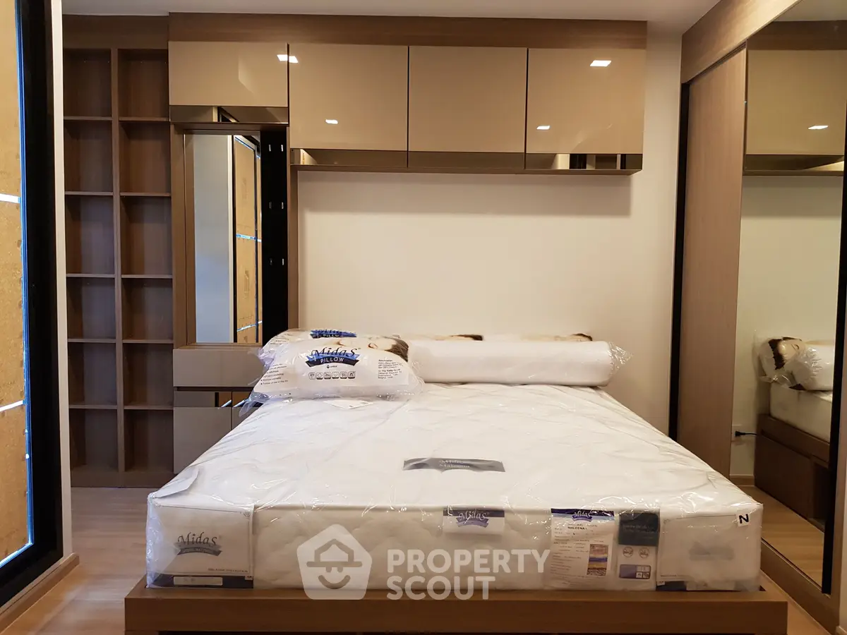 Modern bedroom with sleek design and ample storage in a contemporary apartment.