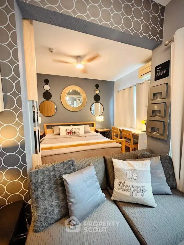 Stylish bedroom with modern decor and cozy seating area, perfect for relaxation and comfort.