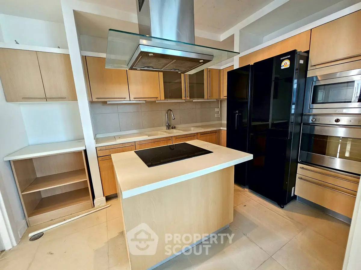Modern kitchen with island, sleek appliances, and ample storage in a contemporary home.