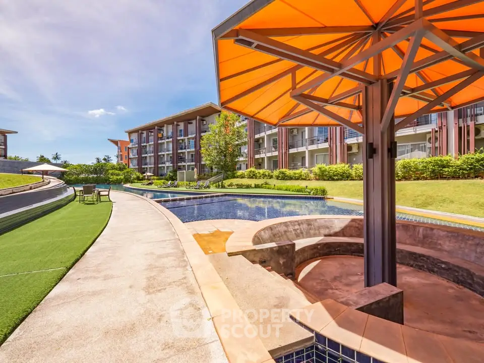 Luxurious outdoor pool area with modern architecture and vibrant landscaping in a high-end residential complex.