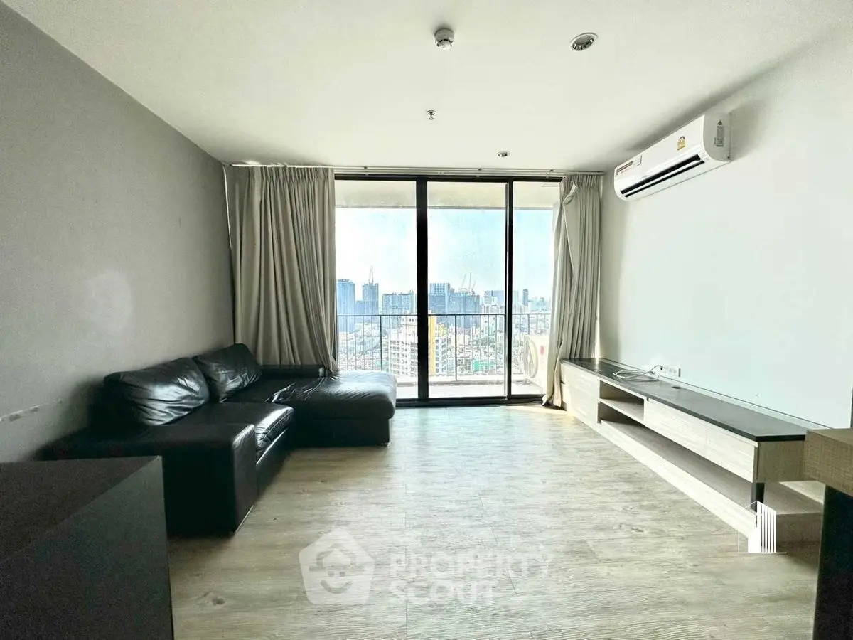 Spacious living room with city view and modern furnishings