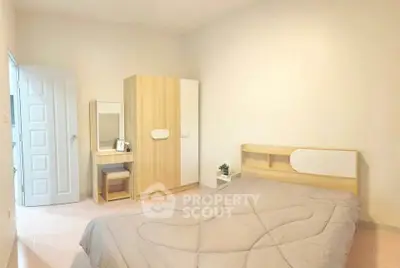 Cozy bedroom with modern wooden furniture and soft lighting, perfect for relaxation.