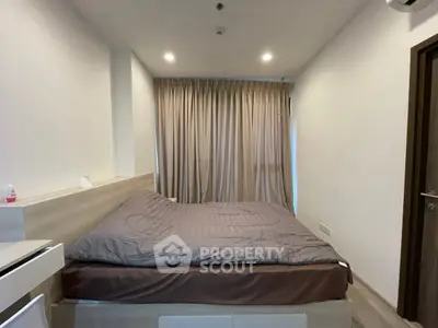 Cozy bedroom with modern design and soft lighting, featuring a comfortable bed and elegant curtains.