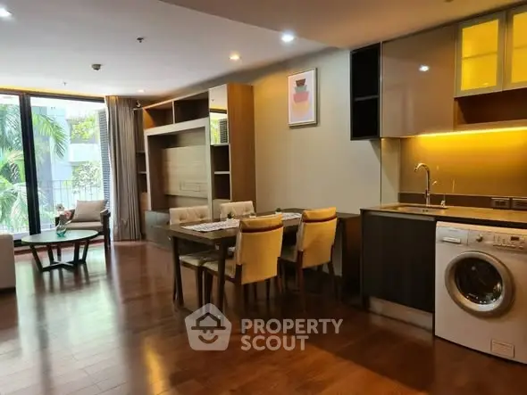 Spacious modern living room with dining area and washing machine in open layout.