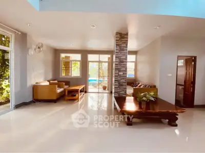 Spacious living room with modern decor and large windows offering natural light.