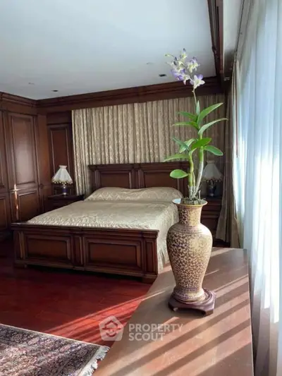 Luxurious bedroom with elegant wood paneling and large windows