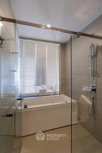 Modern bathroom with sleek glass shower and luxurious bathtub