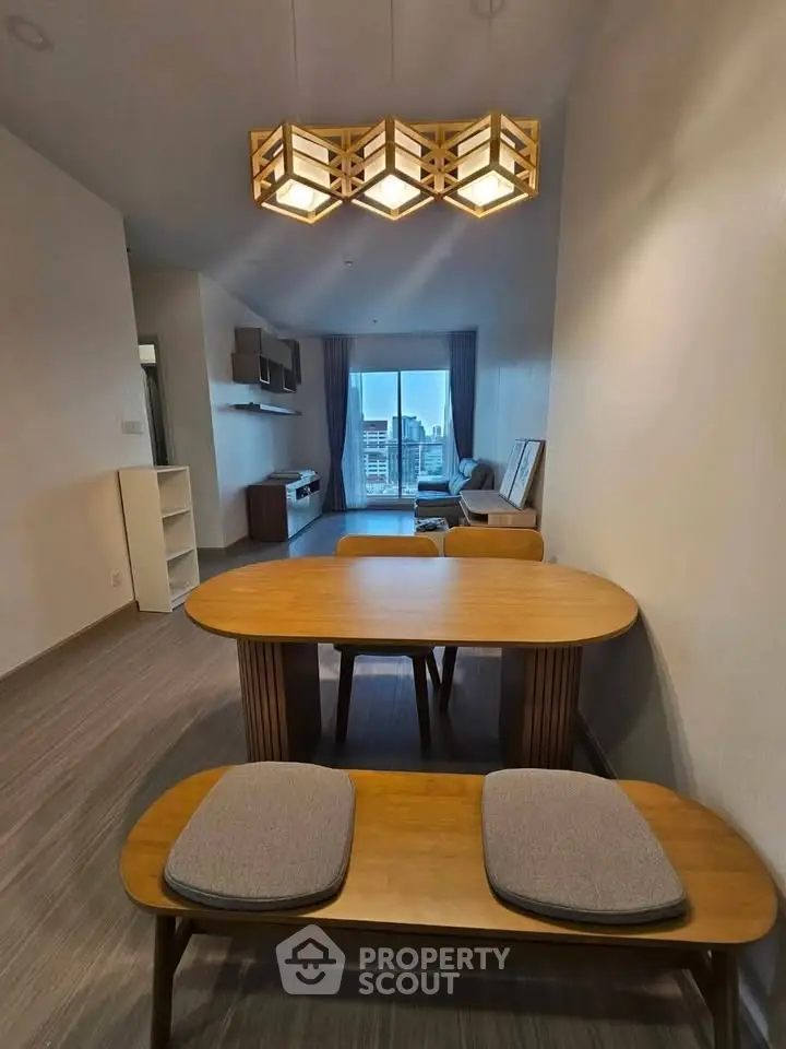 Modern living room with stylish wooden dining set and contemporary lighting