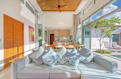 Luxurious open-plan living room with pool view and modern decor