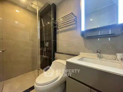 Modern bathroom with sleek fixtures and glass shower enclosure