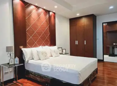 Luxurious bedroom with elegant wood paneling and modern lighting, perfect for a serene retreat.