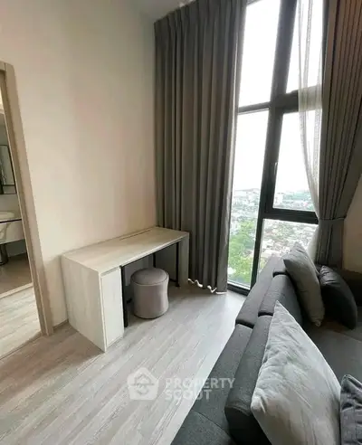 Modern living room with floor-to-ceiling window and stylish furniture