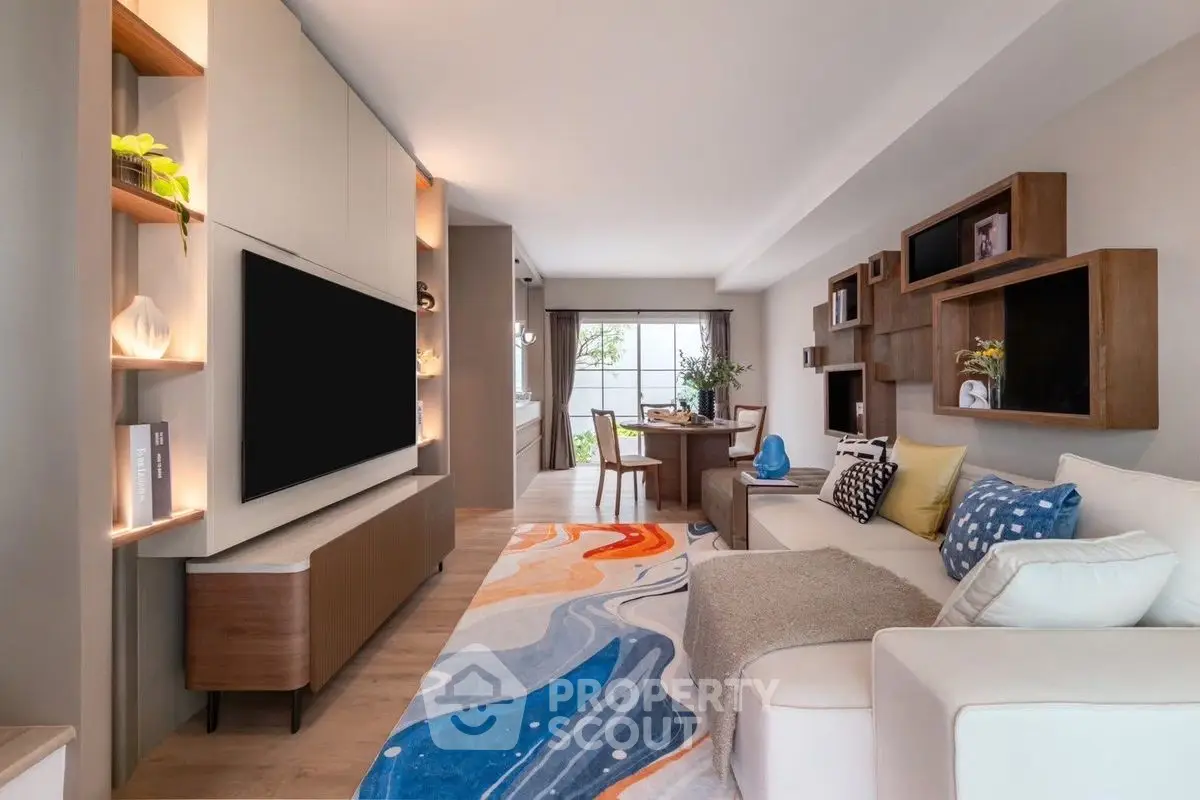 Stylish modern living room with vibrant rug and sleek furniture, perfect for contemporary living.