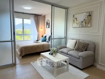 Modern studio apartment with cozy living area and scenic bedroom view.