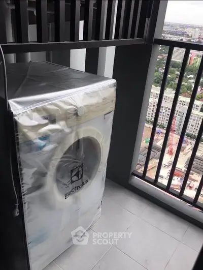 High-rise balcony with washing machine and city view, perfect for urban living convenience.