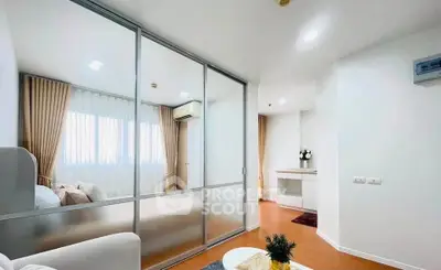 Modern apartment interior with glass partition, cozy living area, and elegant decor.