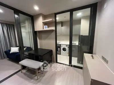 Modern condo interior with glass-enclosed kitchen and cozy living area