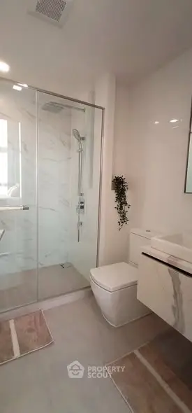 Modern bathroom with glass shower and sleek fixtures