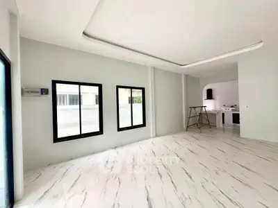 Spacious modern living room with marble flooring and open kitchen layout