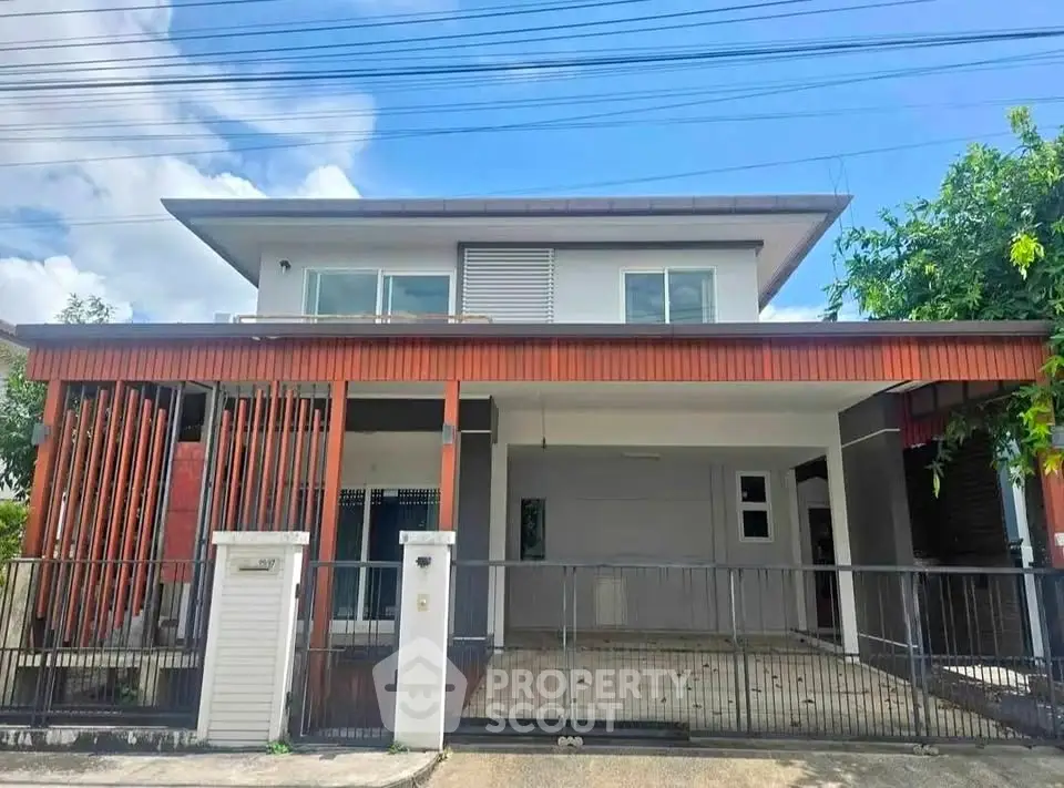 Modern two-story house with spacious carport and sleek design in a serene neighborhood.